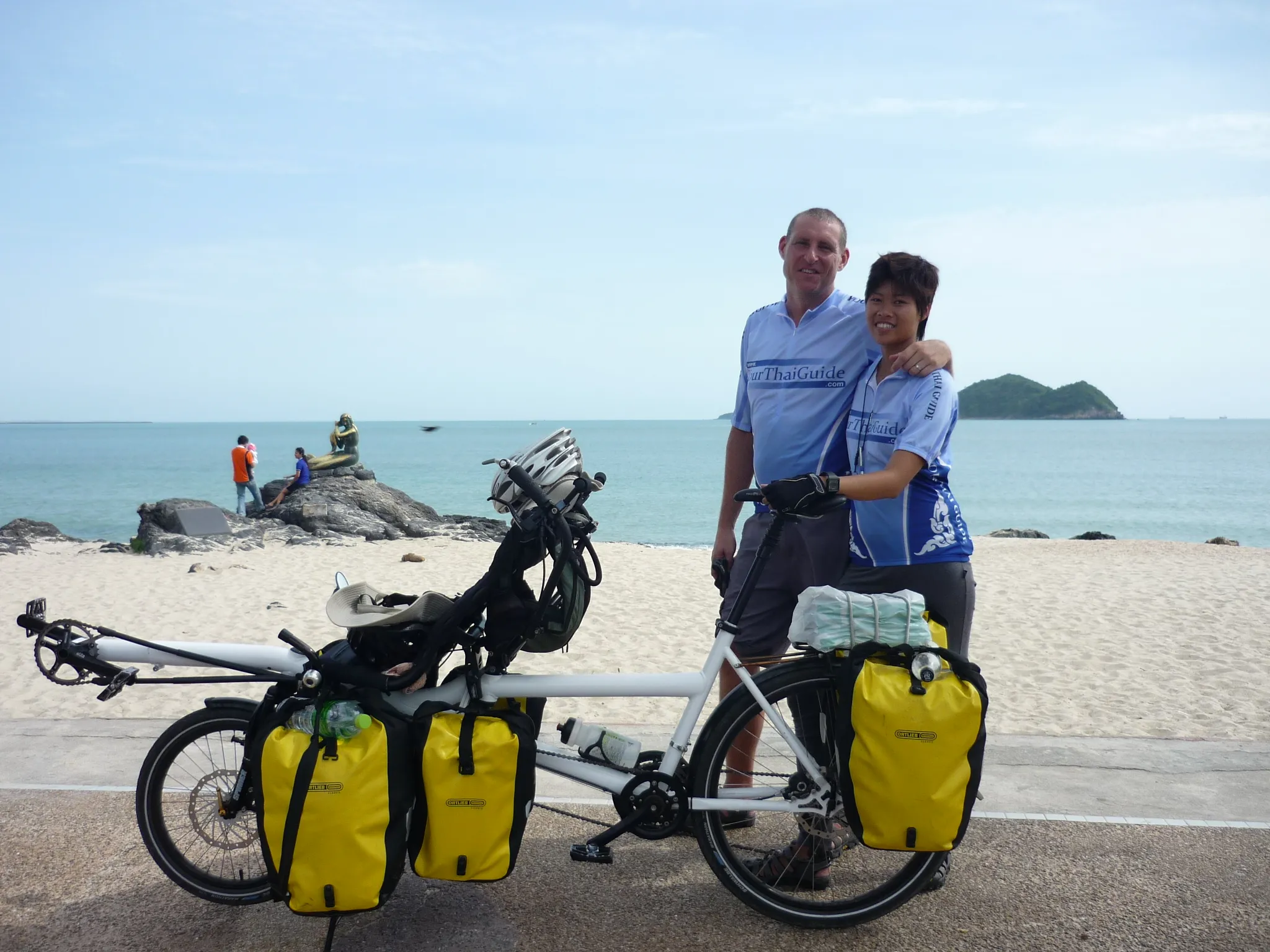 Paul and Natt with their loaded tandem on a beach in the south